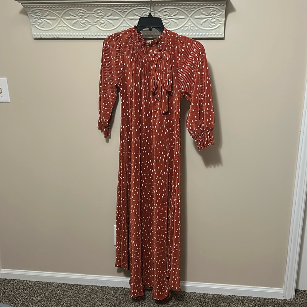 Orange with cream polka dots dress.
